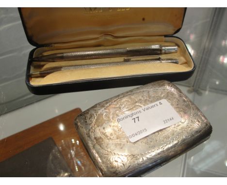 A HM silver cigarette case and two HM silver boxed pencils