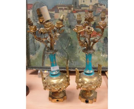 A pair of 19th century lamps with ormolu and ceramic fittings and rose finials