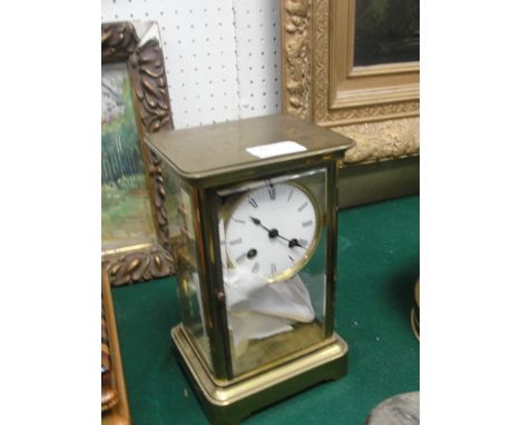 A Victorian glass-cased mantel clock striking on bell