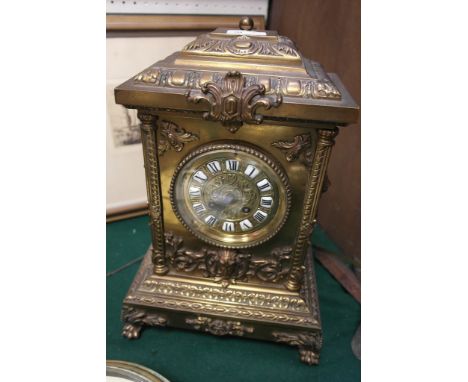 A brass Neo-Classical-style mantel clock