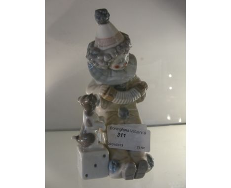 A Lladro figure of a clown with dog and concertina, 5279