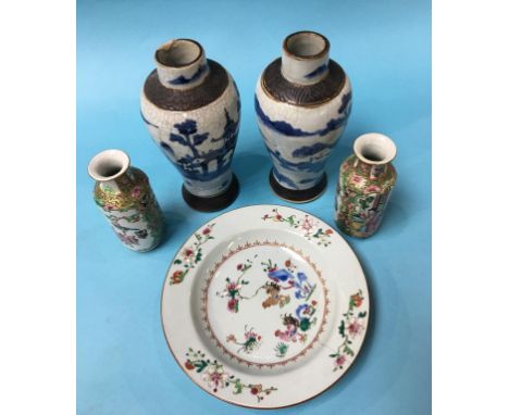 A small pair of Chinese Canton enamel vases, 15cm high, a Chinese plate and a pair of Chinese blue and white vases