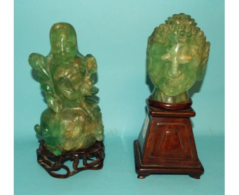 A Chinese jade quartz Buddha head lamp, on a wooden stand, 28 cm high, a similar figural lamp, and hardwood stand, 27 cm high