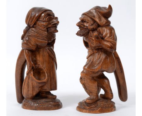 A pair of Black Forest style nutcrackers, in the form of an elderly man and woman, each carved Fluelen, the largest 21 cm hig