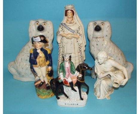 A Worcester porcelain figure, of a kneeling water carrier, 23.5 cm high, a pair of Staffordshire pottery figures, 34.5 cm hig