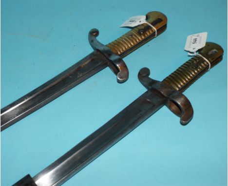 A 19th century French bayonet, dated 1875, and a similar bayonet and scabbard (2)