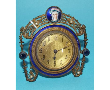 An early 20th century strut timepiece, in a gilt metal case with enamel decoration (a.f.), 9 cm high