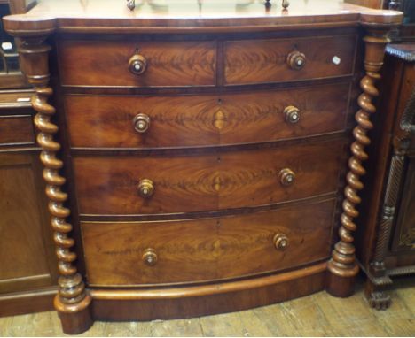 A Victorian bow front mahogany chest, of five drawers, flanked by barley twist columns, 128 cm wide