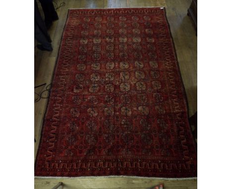 A Persian style carpet, on a red ground, within a multi border, 341 x 220 cm