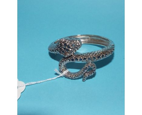 A silver and sapphire snake bangle