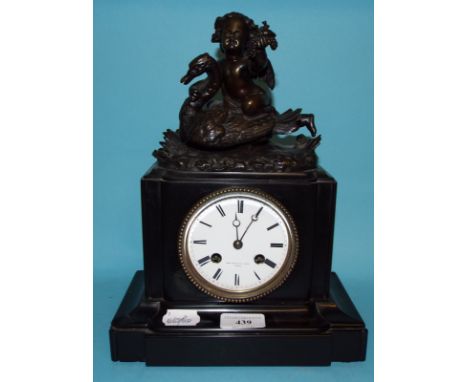 A mantel clock, the white enamel dial with Roman numerals, signed Thos Pearce & Son Paris, in a slate case, applied a cherub 