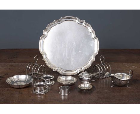 A pair of silver toast racks and further silver consisting of a sauceboat, strawberry dish, napkin ring and two salt cellar f