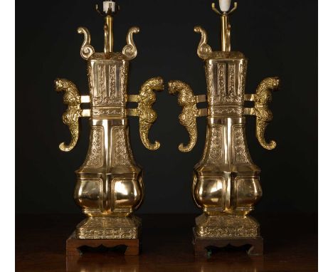 A brass Chinese style table lamps  of archaic form on wooden bases, 67cm high to the light fittingCondition report: Minor mar