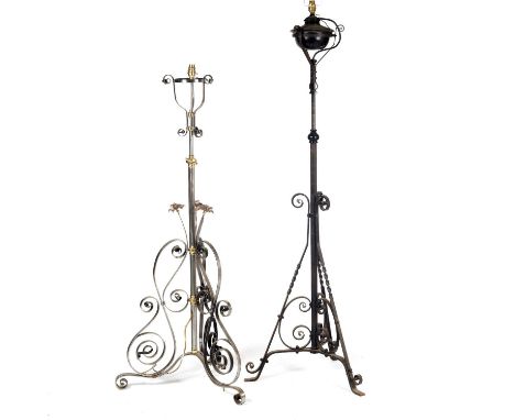 A Victorian steel lamp standard of adjustable height, later converted for electric use and decorated with pressed copper flow