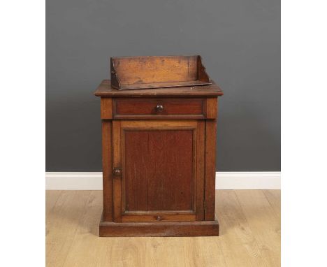 An early Victorian mahogany converted commode cupboard with a lifting top, panelled doors and plinth base, 66cm wide x 52cm d