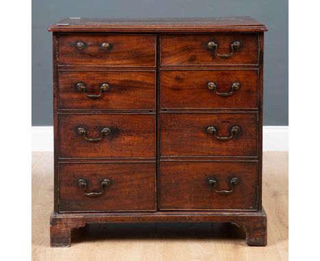 A George III mahogany commode chest converted to a cupboard, having six faux drawers with brass swan handles, side carrying h