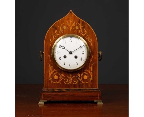 An antique French rosewood cased mantle clock the shaped case with decorative inlay, carrying handles to the side and on bras