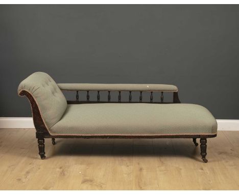An Edwardian upholstered chaise longue with turned legs and casters, 170cm wide x 62cm deep x 68cm high This item was removed