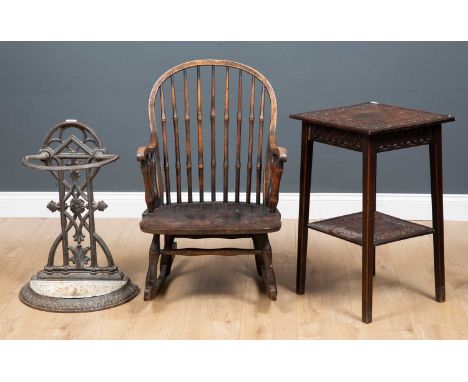 A Victorian cast iron stick stand 43cm wide x 27cm deep x 65cm high together with a spindle back small sized rocking chair, 5