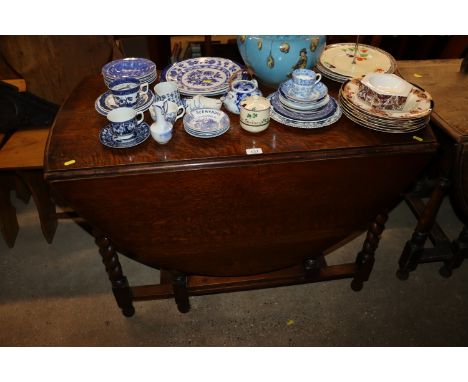 An oak gate leg dining table on barley twist supports