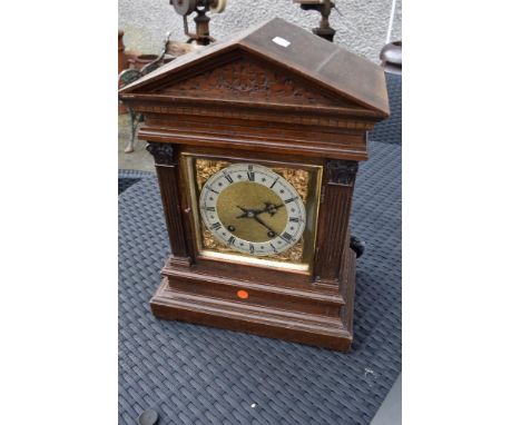 A 19th Century mantel clock in architectural case with brass and silvered roman numeral dial , stamped W &amp; H to movement