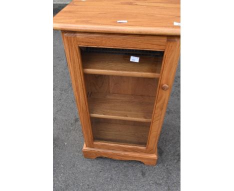 A modern Ercol display cabinet with shelves to side suitable for CDs etc