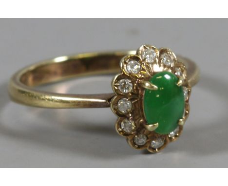 A 14ct gold ring set with jade and diamonds, size M. 