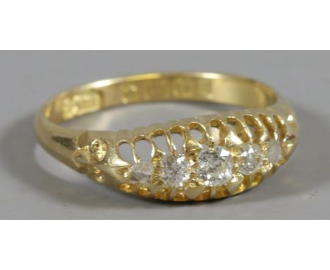 An Edwardian 18ct gold ring with five old European cut diamonds in a boat shaped setting, size M1/2 assayed Birmingham 1906.