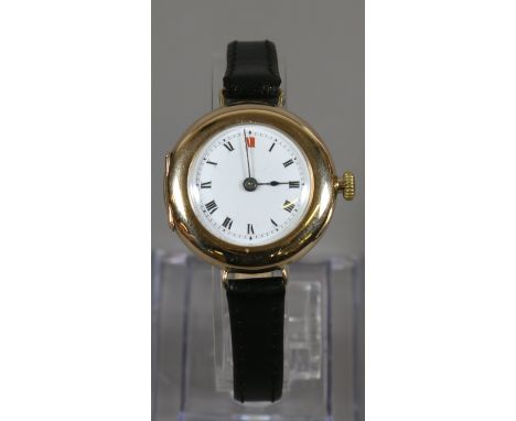 A gentleman's 9ct gold manual wristwatch with white enamel dial Roman numeral markers and black strap, assayed Birmingham 191