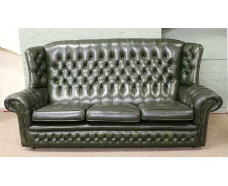 A green leather Chesterfield high back three seat sofa with deep button leather work.