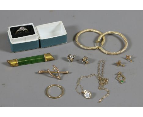 A collection of 9ct gold and yellow metal jewellery. Including earrings, nephrite jade bar brooch and a gem set ring. Marked 