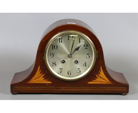 An inlaid mahogany mantel clock chiming on a coiled gong.