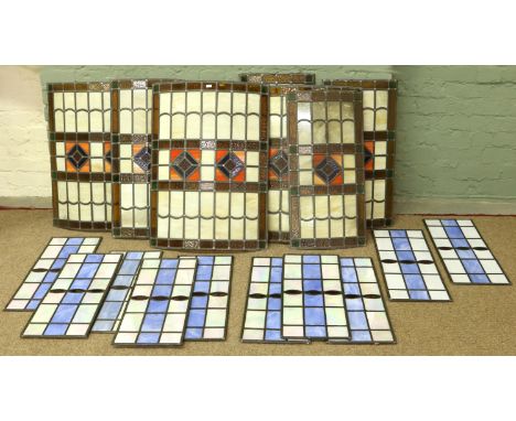 A quantity of rectangular and arch shaped stained glass panels of various designs.