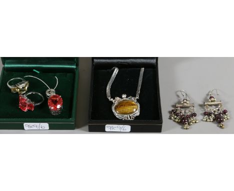 Two cases of silver and gem set jewellery including a suite set with pink gemstones and diamonds, a trilogy ring and a tigers
