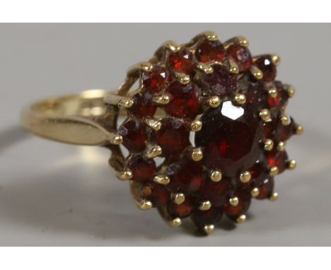 A 9ct gold garnet cluster ring, size L. 