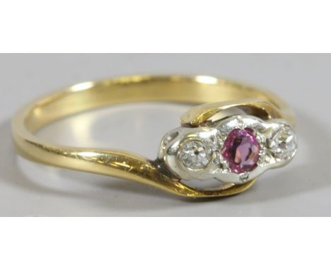 A gold diamond and ruby crossover ring, size L. Unmarked. 