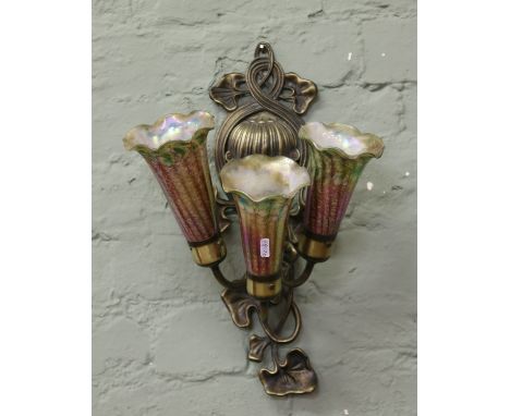 A Tiffany style three branch wall light with irridescent glass shades.