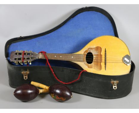 A cased mandolin and a pair of maraca's 