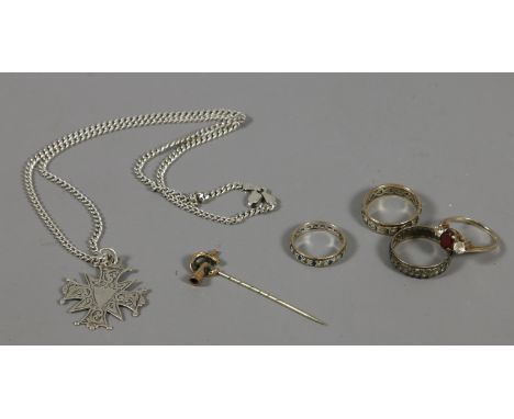 Three eternity rings including gold examples and two with diamonds, a silver medal on chain, a gold gem set ring and a stick 