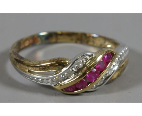 A 9ct gold ring with twisted shank set with diamonds and rubies, size M.