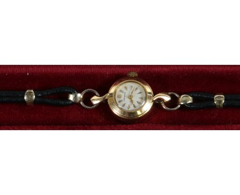 A ladies 18ct gold cased Longines manual wristwatch with scroll shaped lugs and leather strap. 