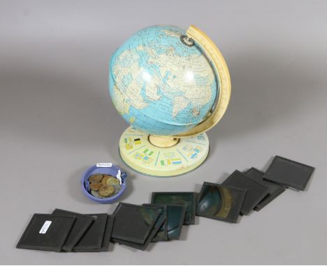A tinplate globe and coins along with a collection of photographic slides.