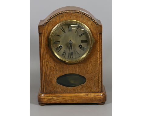 An oak cased dome top mantel clock with brass dial and Roman numeral marker chiming on a coiled gong manufactured Wurttemberg