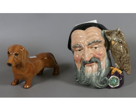 A Beswick model of a dachshund and a Royal Doulton character jug, Merlin
