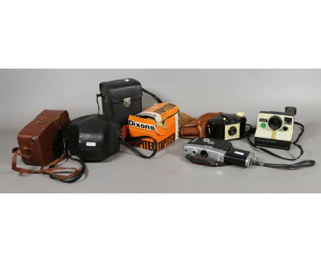 A collection of cameras to include Praktika, Polaroid, Kodak and Fujica examples.