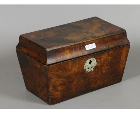 A C19th figured walnut tea caddy with mother of pearl escutcheon and fitted interior.