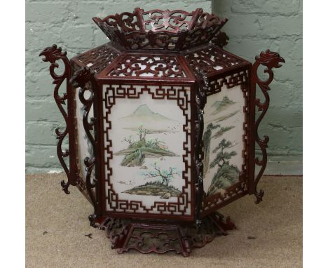 A reproduction oriental lantern with decorated glass panels.