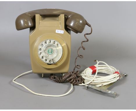 A British Telecoms postoffice model 741 wall mounted dial telephone.