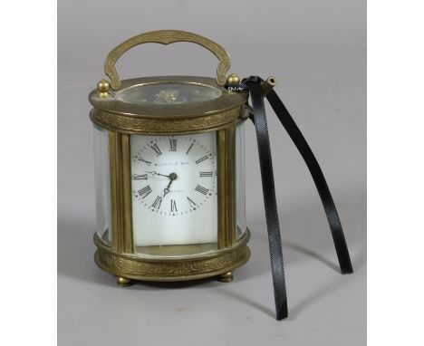 An oval brass cased carriage clock having platform escapement and with enamel dial signed Elliot & Son. 