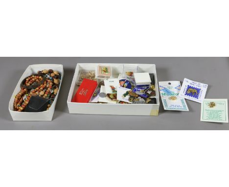 A box of jewellery and collectables including a silver bangle, enamel badges and rosary beads and a box of gold coloured frag